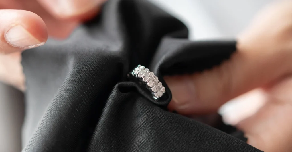 Hand gently cleaning daimond ring